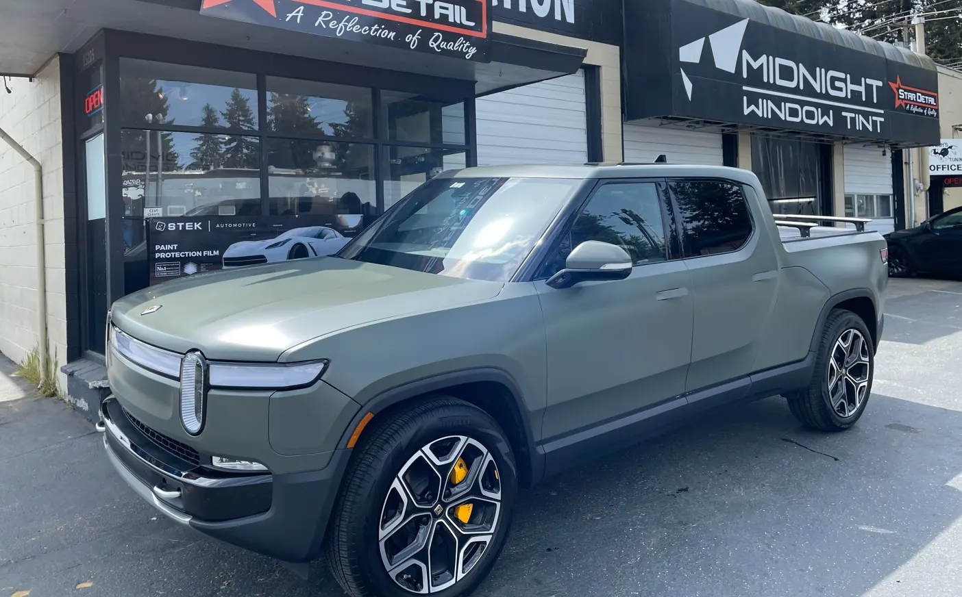Rivian R1S with ceramic tint outside the shop